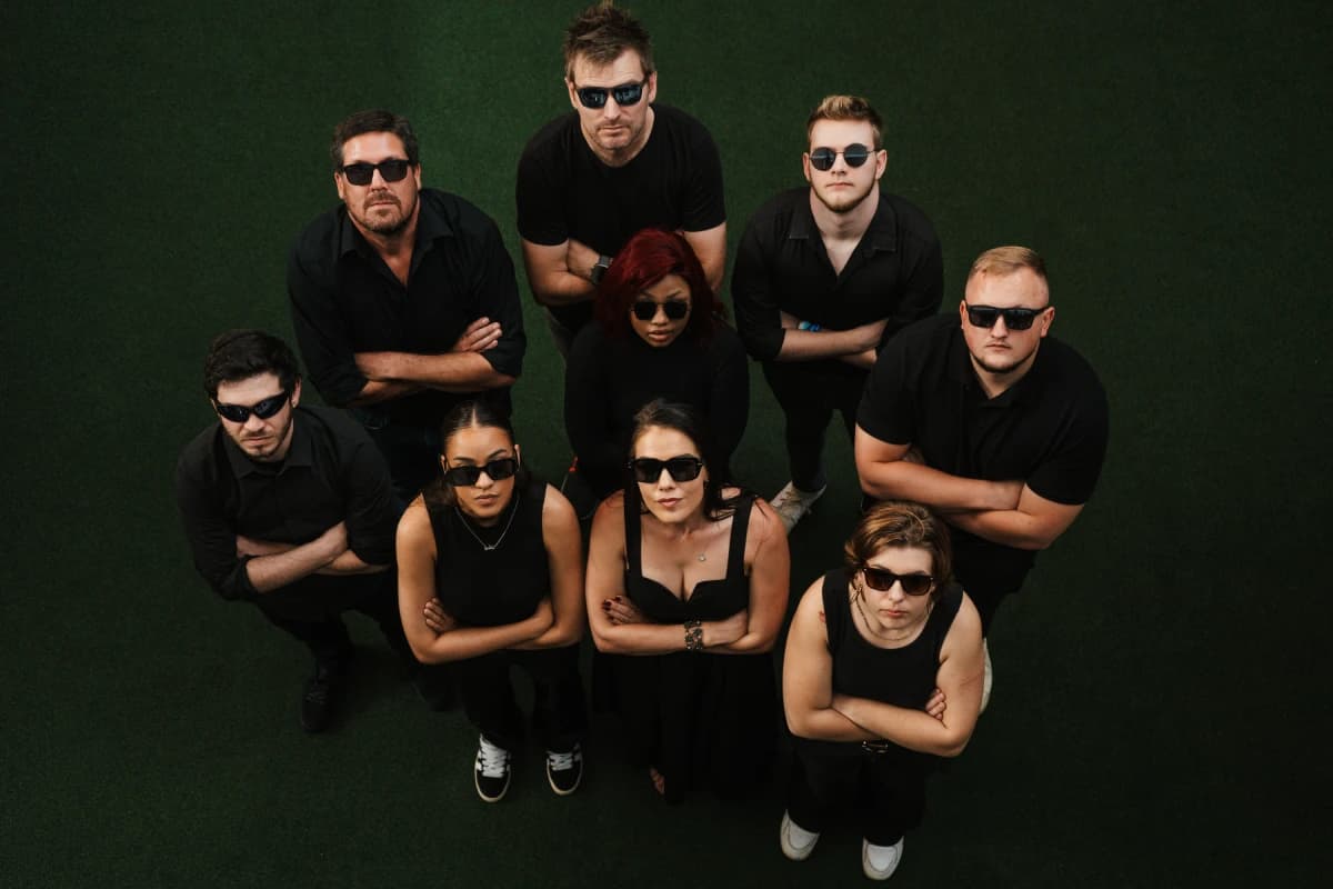 Kickass Collective digital marketing team dressed in black, looking up at camera. Bold agency photo in Gauteng